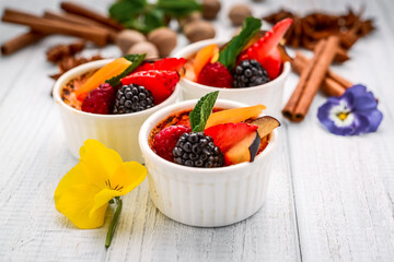 Dessert with fresh fruits on wooden background.