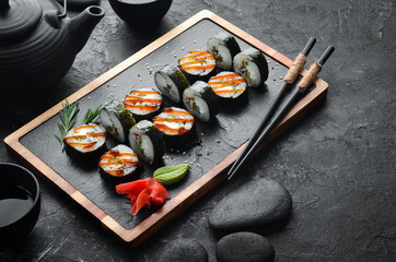 Sushi rolls of seafood - Okinawa. Eel fish, cheese, cucumber and Unagi sauce. Japanese traditional food