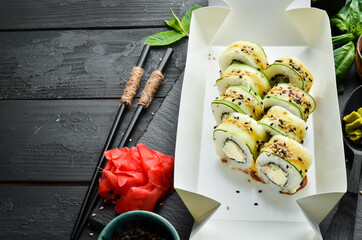 Sushi rolls with cucumber, sesame and Philadelphia cheese. Japanese food. Traditional sushi. Top...