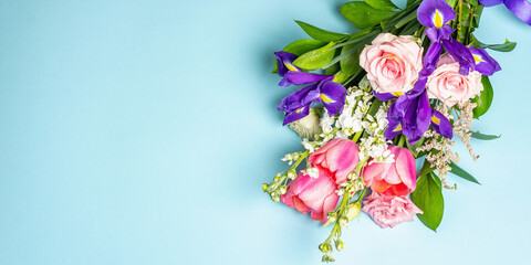 A beautiful bouquet of fresh flowers on a blue pastel background