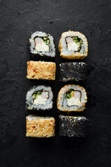 Traditional Sushi - Black and White, with crab, cheese and herbs. Japanese cuisine. Top view.