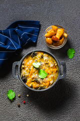 Hearty mushroom gravy in cast iron pot. Space for text, top view.