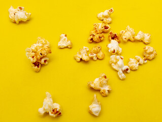 Close-up of popcorn on a yellow background.