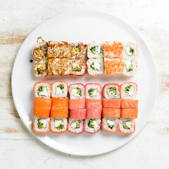 Set: sushi rolls with eel, sesame, avocado and fish. Japanese food. Top view. On a white background.