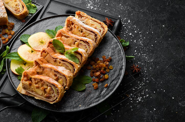Sweet Strudel with apples and dried fruits. Top view, free copy space.