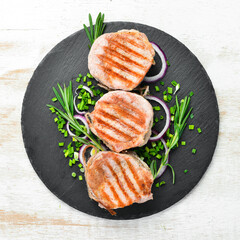 Roasted BBQ Pork medallions with rosemary and spices. Top view. Free space for your text.
