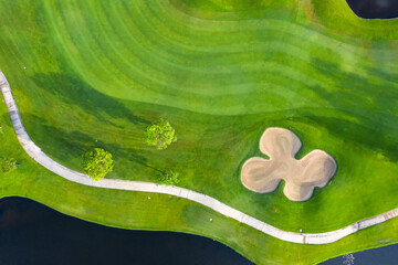 Aerial view of green grass and trees on a golf field, fairway and putting green top view, Bangkok...