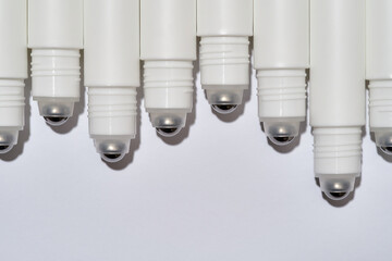 Cropped shot of tubes for eye roller skin care product isolated over white background