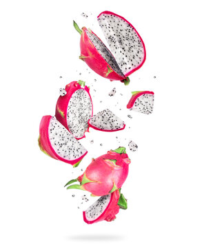 Sliced ripe dragon fruits (pitahaya) in the air on a white background