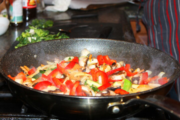 A close-up of  vegetables being stir-fried  in a frying pan for the Korean beef stir fry dish bulgogi.