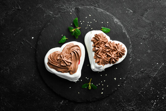 Pavlov's dessert. Bizet cakes with chocolate. Sweets. Top view. Rustic style.