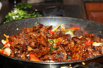 A close-up of Bulgogi, a Korean beef stir-fry, in a frying pan.