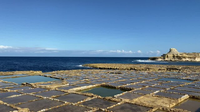 Xwejni Salt Pans on coast of Gozo, Malta, panning shot