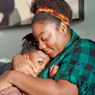 African American mother comforting daughter