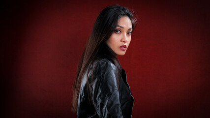 Naklejka premium Sexy Asian woman poses in the studio for the camera - studio photography