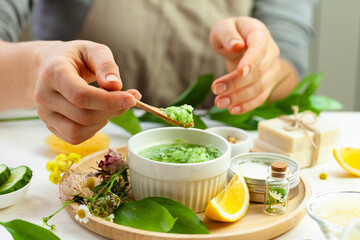 Girl in process of preparation of homemade refreshing cucumber mask. Self care, home face and body treatment durine lockdown. Concept of natural organic ingredients and essential oil in cosmetics