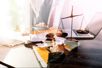 Business and lawyers discussing contract papers with brass scale on desk in office. Law, legal services, advice, justice and law concept picture with film grain effect