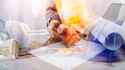 architect man working with blueprints,engineer inspection in workplace for architectural plan,sketching a construction project ,selective focus.