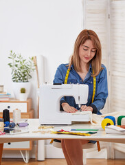 The young tailor working on the sewing machine