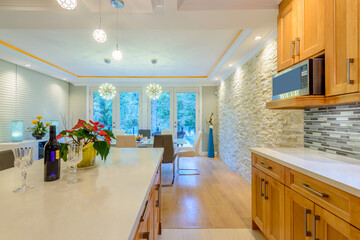 Modern, bright, clean, kitchen interior with stainless steel appliances in a luxury house