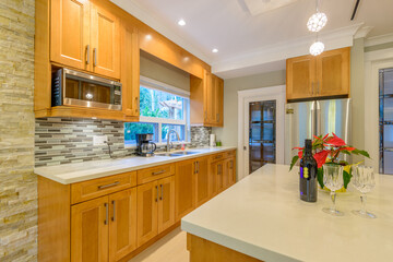 Modern, bright, clean, kitchen interior with stainless steel appliances in a luxury house