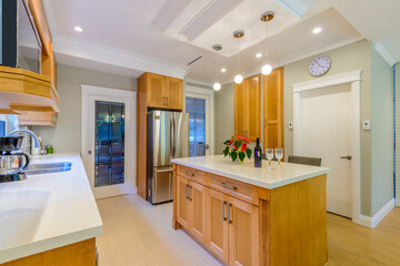 Modern, bright, clean, kitchen interior with stainless steel appliances in a luxury house
