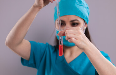 Female doctor examines a blood sample - studio photography