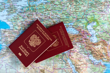 Two Russian passports against the background of a geographic map.