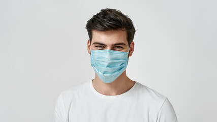 Man wearing medical mask looking at the camera