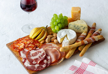 Wine snack. Jamon, camembert, chorizo, almonds, blue cheese, parmesan. Antipasti. Wine appetizer.