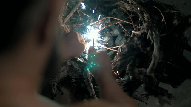 The fire flares up and burns from the flint