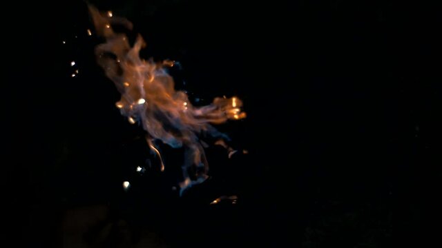 Man lights a fire in the dark with a flint