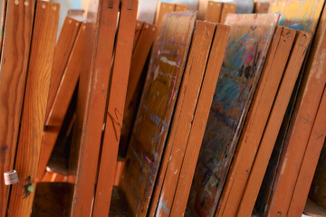 Fototapeta na wymiar Lots of wooden folded easels for artists