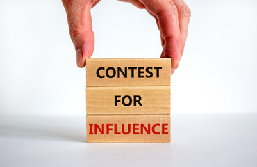 Contest for influence symbol. Wooden blocks with words 'Contest for influence'. Beautiful white background, businessman hand. Business, contest for influence concept, copy space.
