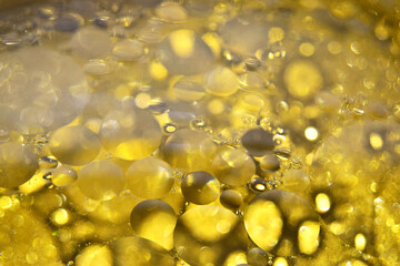Defocused abstract background with yellow bubbles of oil in water. Macro photography, bocque. View from above