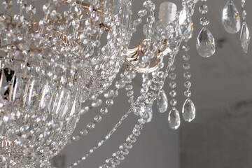 A Chrystal chandelier close-up. Glamour white light background with copy space