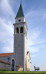 Fototapeta premium Church of St Vid in village Kostanjevica na Krasu with garden bench on Carso, karst, kras, Slovenia