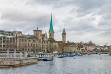 View of historic Zurich city center with famous Fraumunster and river Limmat at Lake Zurich on a cloudy day in winter, Zurich, Switzerland.