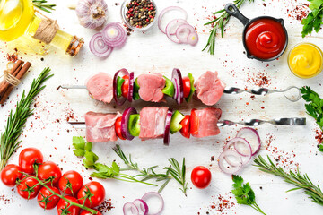 Raw veal kebab with rosemary and vegetables. Top view. Free space for your text.