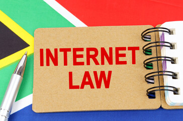 Against the background of the flag of South Africa lies a notebook with the inscription - INTERNET LAW