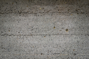 Gray concrete wall covered with a rough layer of cement. Background for design
