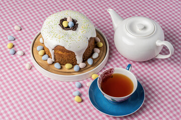 decorated Easter cake on a table with cup of tea