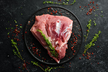 fresh raw pork shoulder with ingredients and spices on kitchen background. Meat. Top view. Rustic...