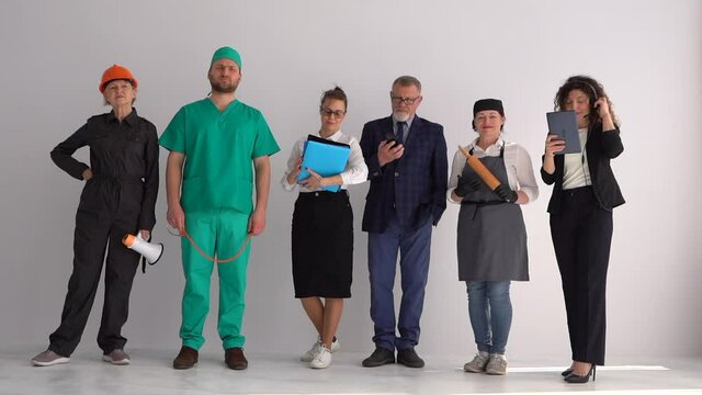 Group of happy business people with different occupations. People of different professions on a white background in the studio