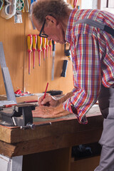 Carpenter working on the work bench, joinery tools and woodwork