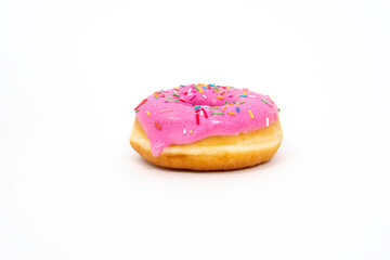 Donut with pink glaze and colored sprinkles on a light background