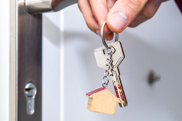 hands with house keys at the front door