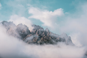 Fototapeta na wymiar Clouds over mountain peaks in the Dolomites, Italy.