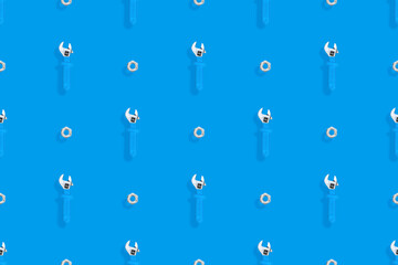 Wrench with nut seamless pattern. Background on the theme of repair or construction. 