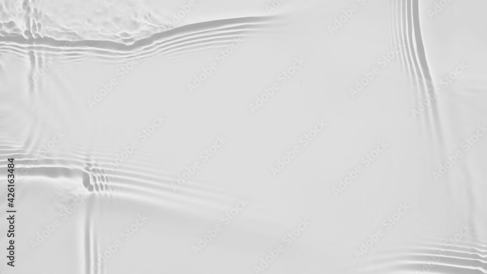 Poster up close, top view, slow motion various waves of the water surface hitting the sun's rays, making th
